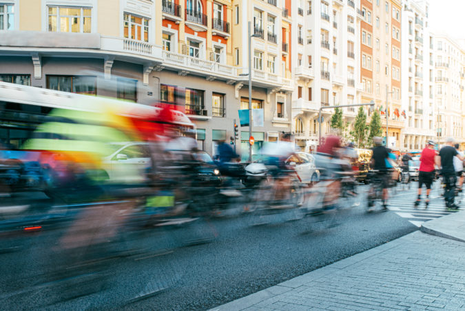 Blurred group of cyclist riding on madrid city center